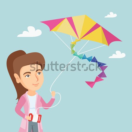 Young african-american woman flying kite. Stock photo © RAStudio