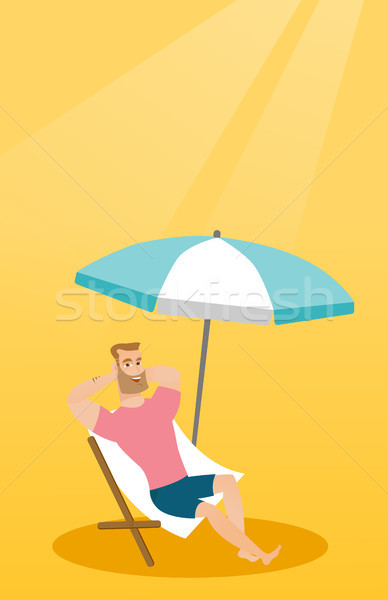 Young caucasian man relaxing on the beach chair. Stock photo © RAStudio