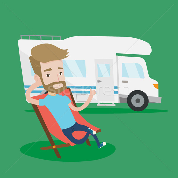 Man sitting in chair in front of camper van. Stock photo © RAStudio