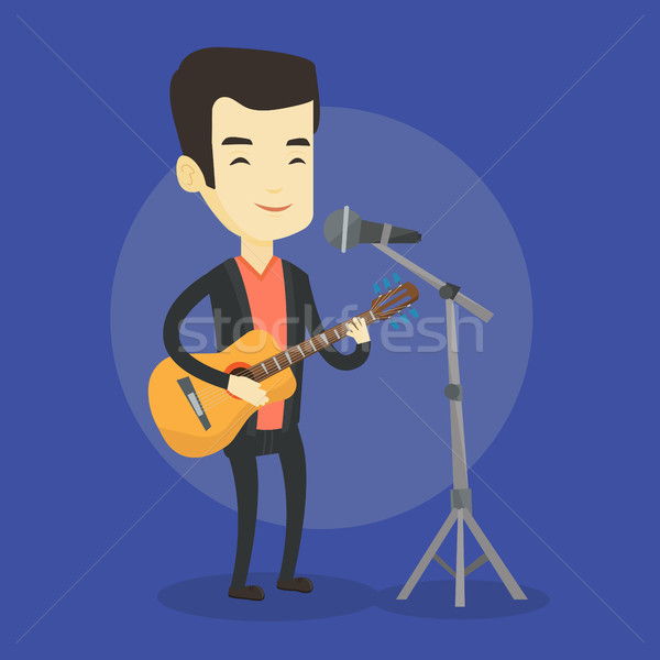 Man singing in microphone and playing guitar. Stock photo © RAStudio