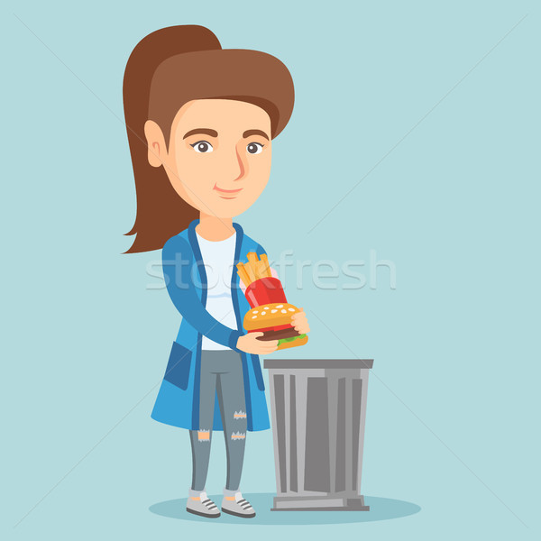 Woman throwing out junk food into the trash can. Stock photo © RAStudio