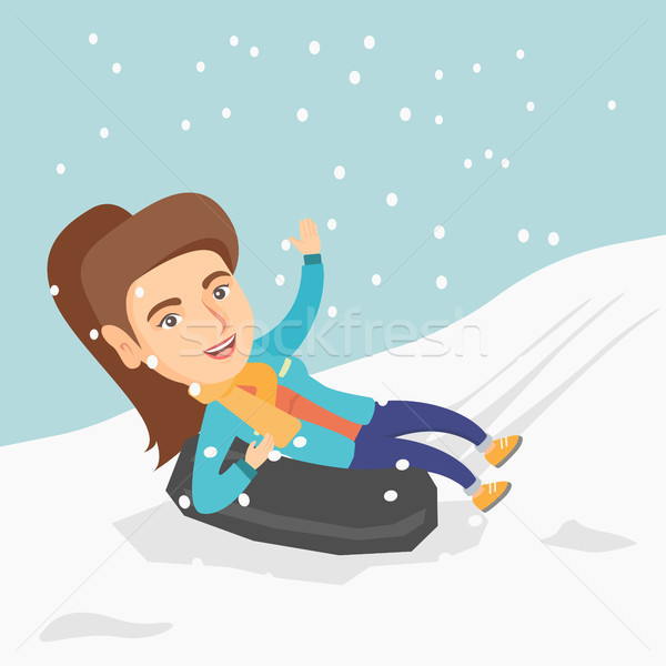 Girl sledding on snow rubber tube in the mountains Stock photo © RAStudio