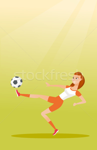 Young caucasian soccer player kicking a ball. Stock photo © RAStudio