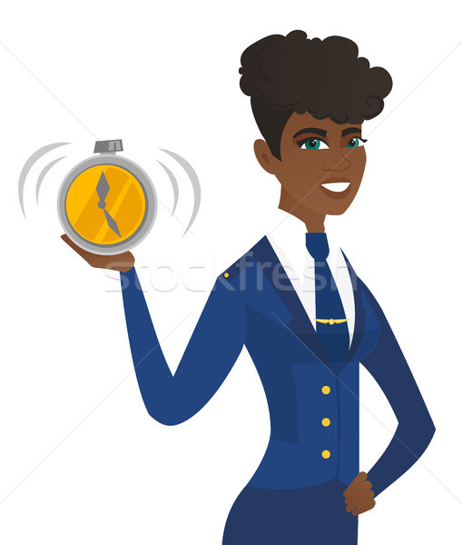 Arican-american stewardess holding alarm clock. Stock photo © RAStudio