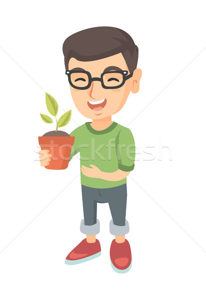 Caucasian smiling boy holding a potted plant. Stock photo © RAStudio