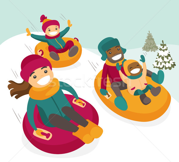 Multiethnic family sliding down the hill on tubes. Stock photo © RAStudio