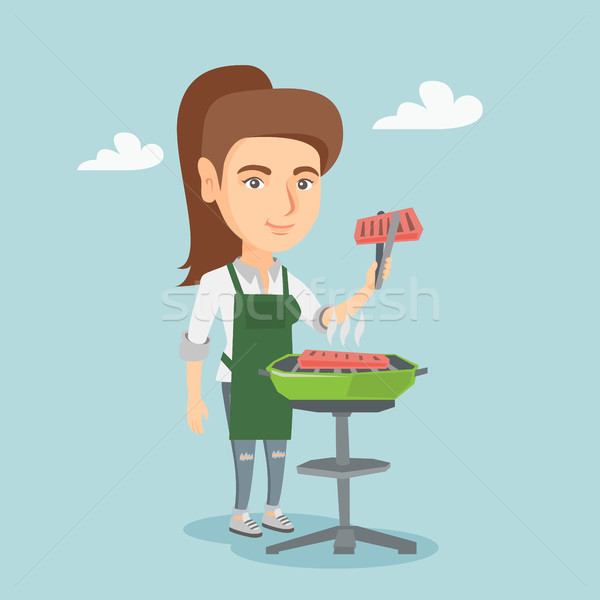 Caucasian woman cooking steak on the barbecue. Stock photo © RAStudio