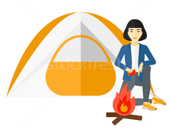 Woman kindling fire. Stock photo © RAStudio