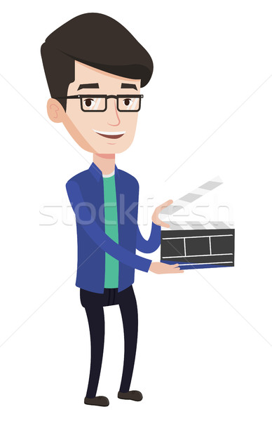 Smiling man holding an open clapperboard. Stock photo © RAStudio