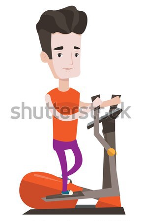 Stock photo: Man exercising on elliptical trainer.