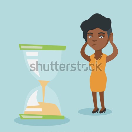 Stock photo: Desperate businessman looking at hourglass.