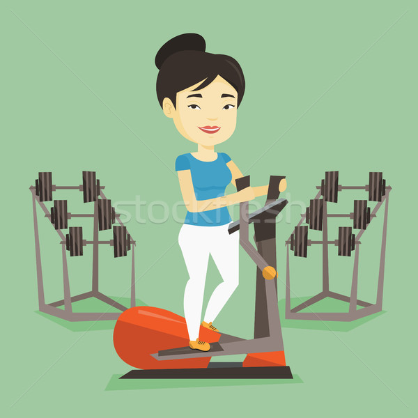 Woman exercising on elliptical trainer. Stock photo © RAStudio