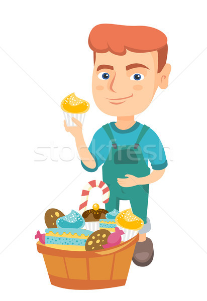 Boy holding a cupcake and stroking his belly. Stock photo © RAStudio