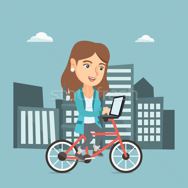 Business woman riding a bicycle with a laptop. Stock photo © RAStudio