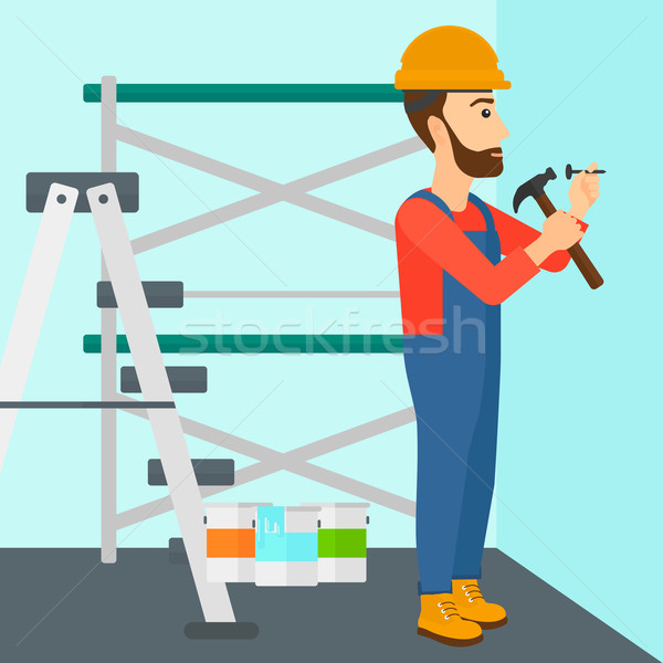 Constructor hammering nail. Stock photo © RAStudio
