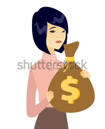 Upset young asian farmer holding a money bag. Stock photo © RAStudio
