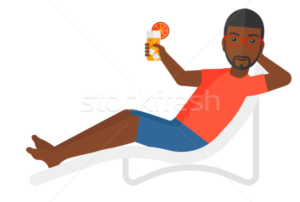 Stock photo: Man sitting in chaise longue.