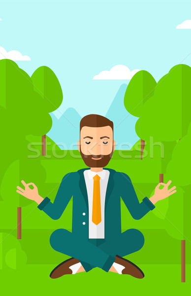 Stock photo: Businessman meditating in lotus pose.