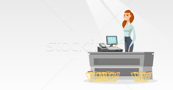 Cashier standing at the checkout in a supermarket. Stock photo © RAStudio