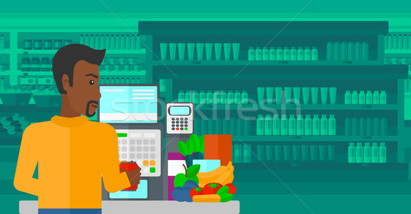 Cashier at supermarket checkout. Stock photo © RAStudio