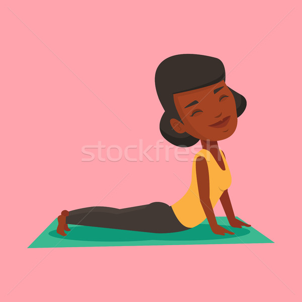 Woman practicing yoga upward dog pose. Stock photo © RAStudio