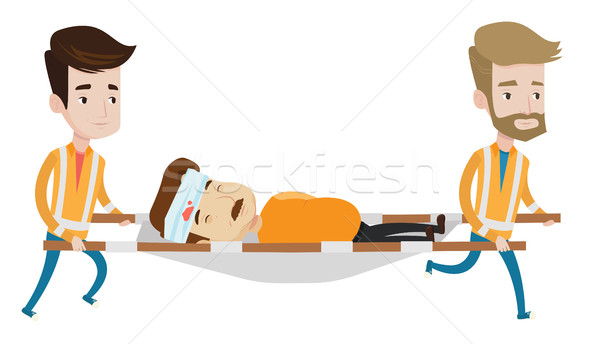 Stock photo: Emergency doctors carrying man on stretcher.