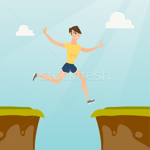 Young caucasian sportswoman jumping over the cliff Stock photo © RAStudio