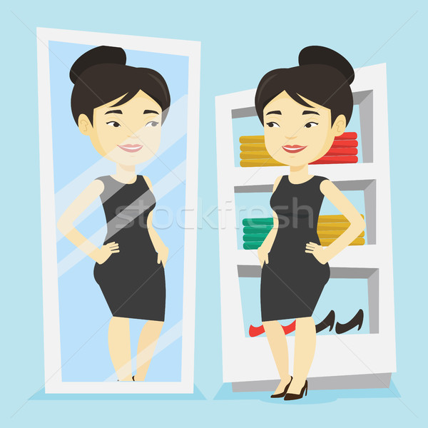 Woman trying on clothes in dressing room. Stock photo © RAStudio