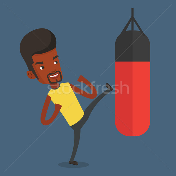 Man exercising with punching bag. Stock photo © RAStudio