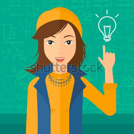 Stock photo: Woman pointing at light bulb.