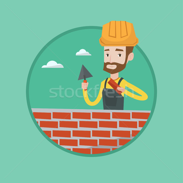 Bricklayer working with spatula and brick. Stock photo © RAStudio