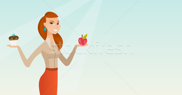 Woman choosing between apple and cupcake. Stock photo © RAStudio