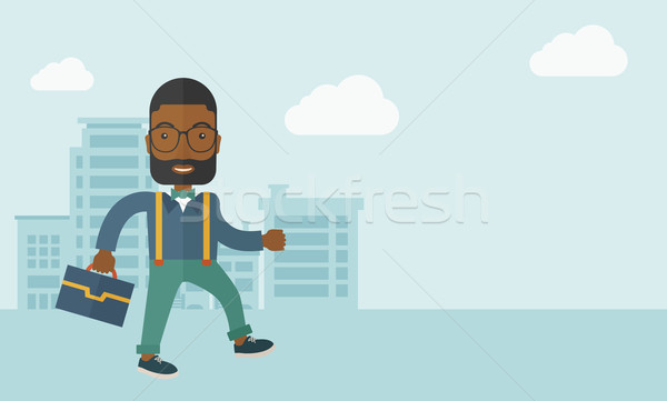 Young man walking through the city's street with his briefcase. Stock photo © RAStudio