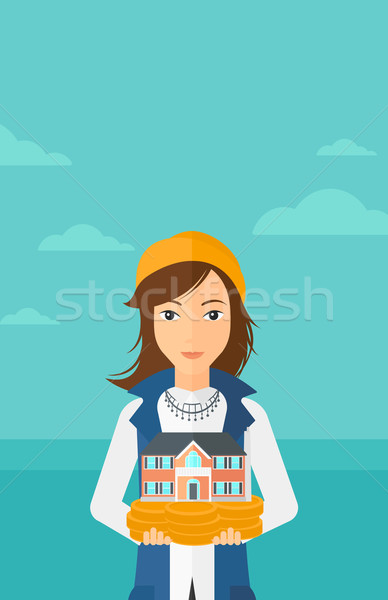 Woman holding house model. Stock photo © RAStudio