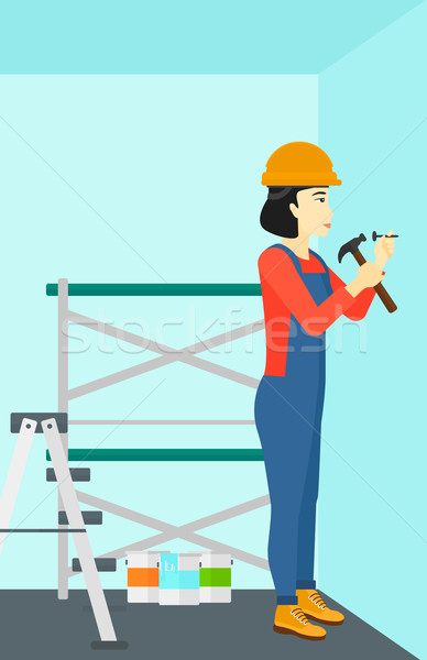 Constructor hammering nail. Stock photo © RAStudio