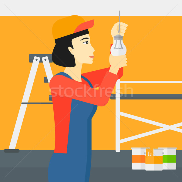 Electrician twisting light bulb. Stock photo © RAStudio