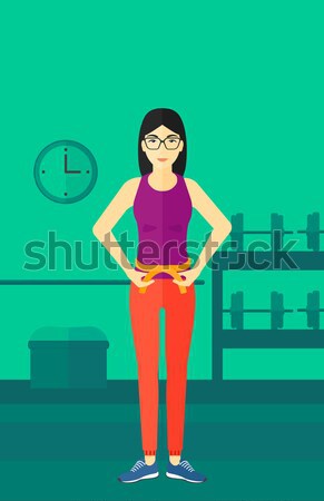 Woman measuring waist. Stock photo © RAStudio