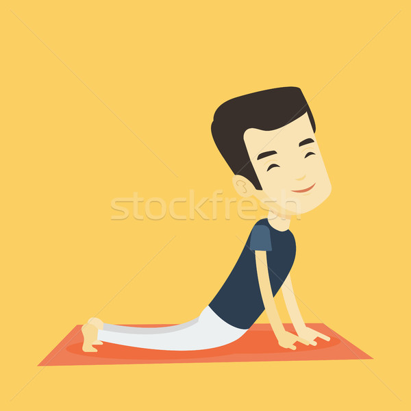 Man practicing yoga upward dog pose. Stock photo © RAStudio