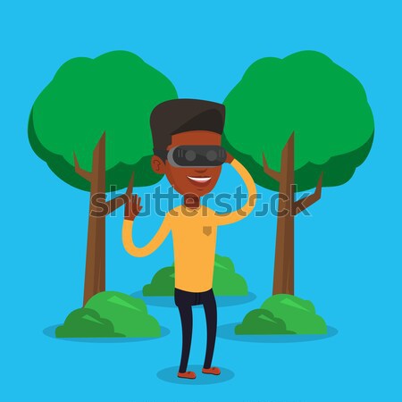 Woman wearing virtual reality headset in the park. Stock photo © RAStudio