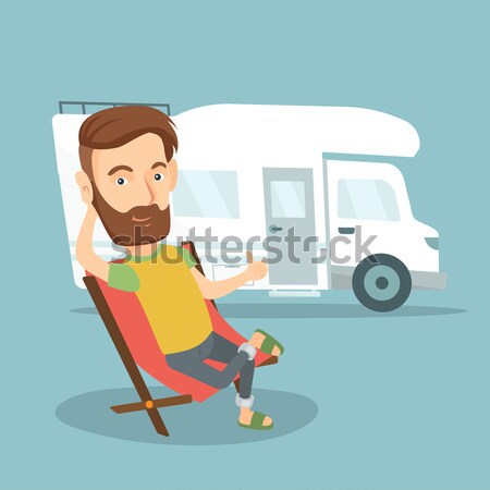 Woman sitting in chair in front of camper van. Stock photo © RAStudio