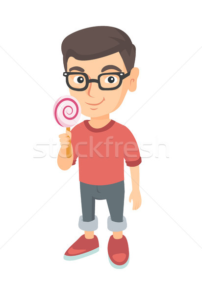 Little caucasian boy holding a lollipop candy. Stock photo © RAStudio