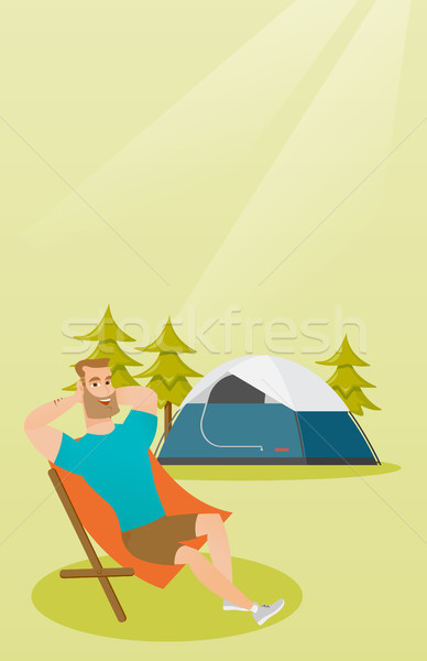 Man sitting in a folding chair in the camping. Stock photo © RAStudio