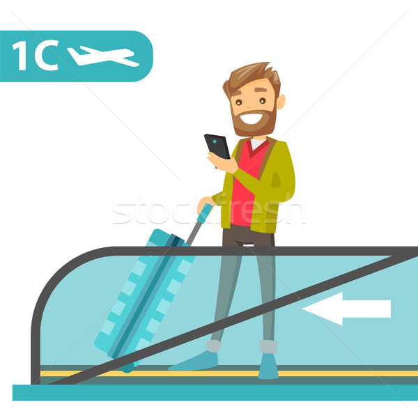 A traveller in an airport with a smartphone and a suitcase. Stock photo © RAStudio