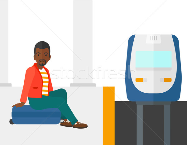 Człowiek posiedzenia kolej żelazna czeka pociągu Zdjęcia stock © RAStudio