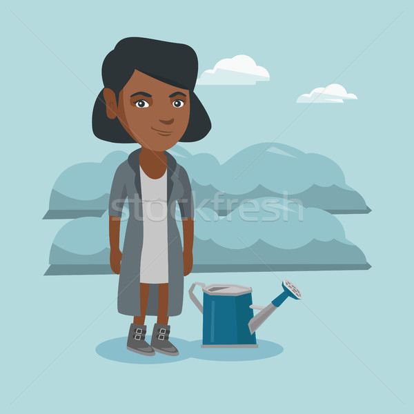 Young farmer standing in a field with watering can Stock photo © RAStudio