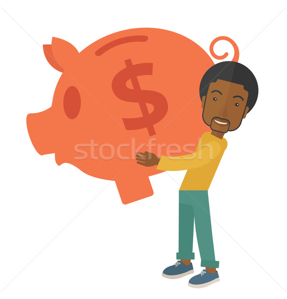 African businessman carries a big piggy bank for saving money. Stock photo © RAStudio