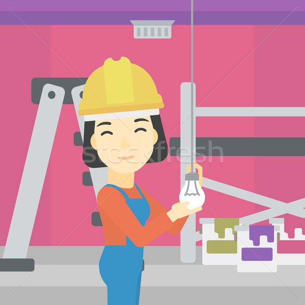 Electrician twisting light bulb. Stock photo © RAStudio