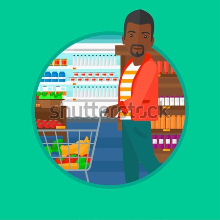Customer with shopping trolley at supermarket. Stock photo © RAStudio