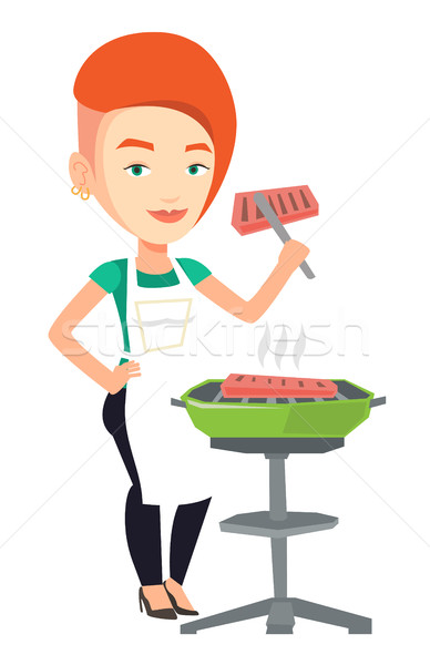 Woman cooking steak on barbecue grill. Stock photo © RAStudio