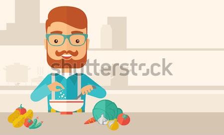 Young caucasian is eating salad for lunch in the restaurant. Stock photo © RAStudio